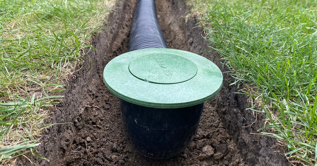 Green lawn drain box connected to pipe